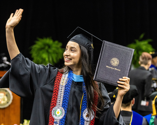 Student graduating in cap and gown.