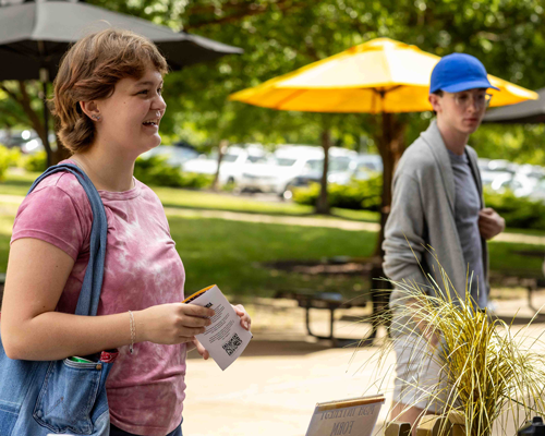 Student talking to MSA student at event.