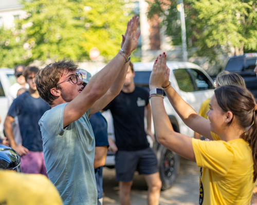 Students high fiving at MSA event.