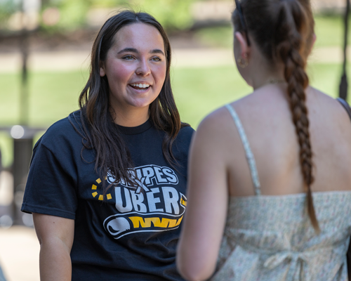 Student talking to other student about STRIPES program.